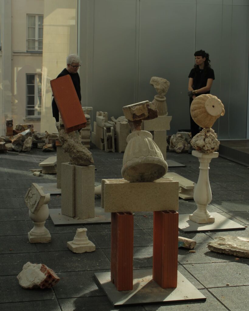 Rock balancing contemporary sculpture demonstration by artist Bridget Polk in Paris