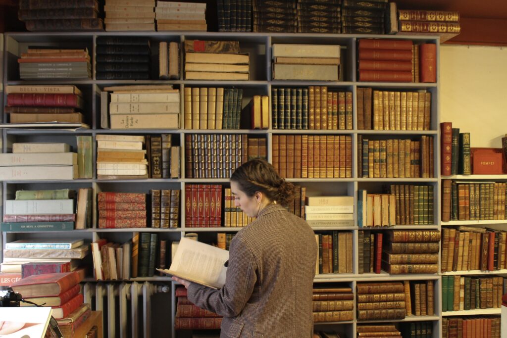 Vintage atmosphere inside L'Escurial bookstore showing rare books and warm lighting