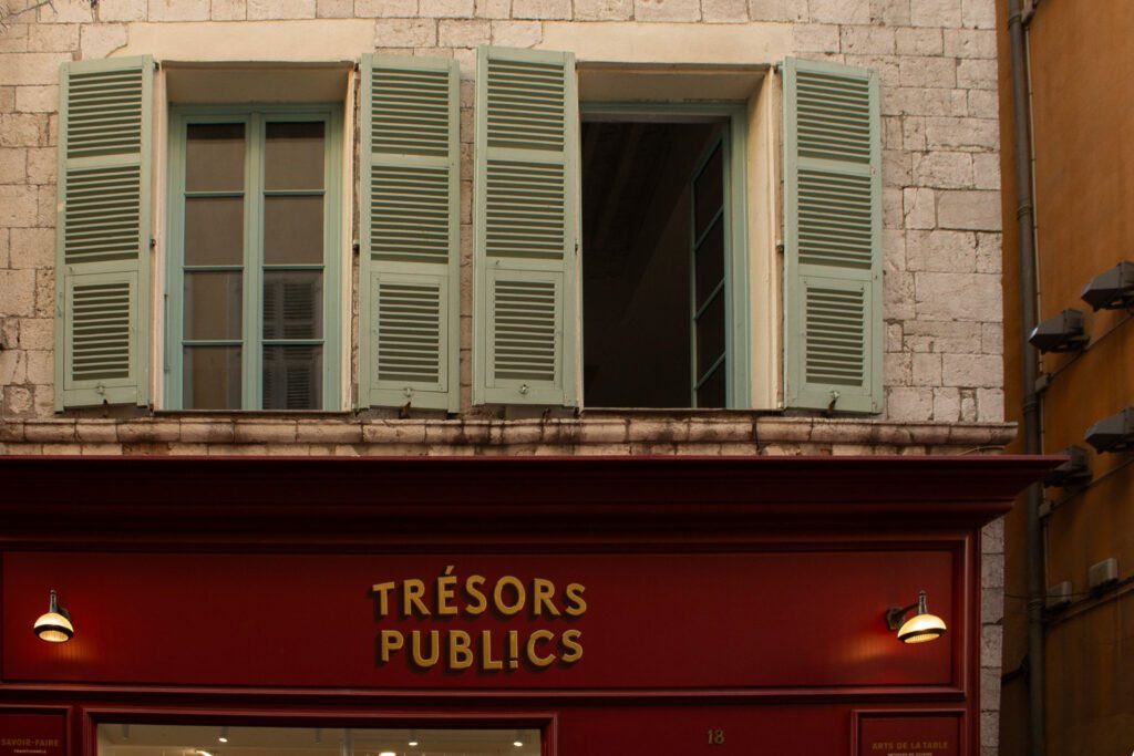 Window display featuring traditional French objects and heritage products at artisan boutique in Old Nice